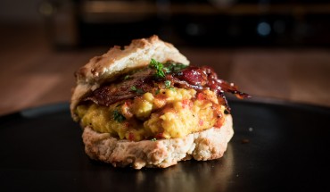 Scones topped with scrambled eggs and bacon